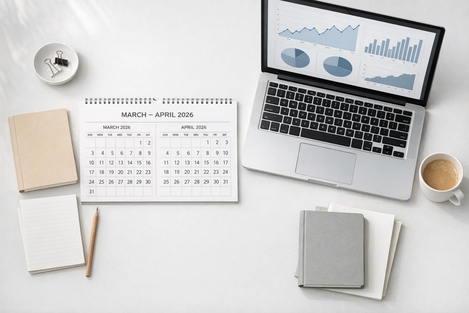 Desk scene with March–April 2026 calendar and analytics charts